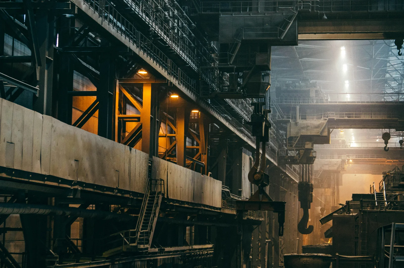 Gantry cranes and lifting hooks inside an industrial factory