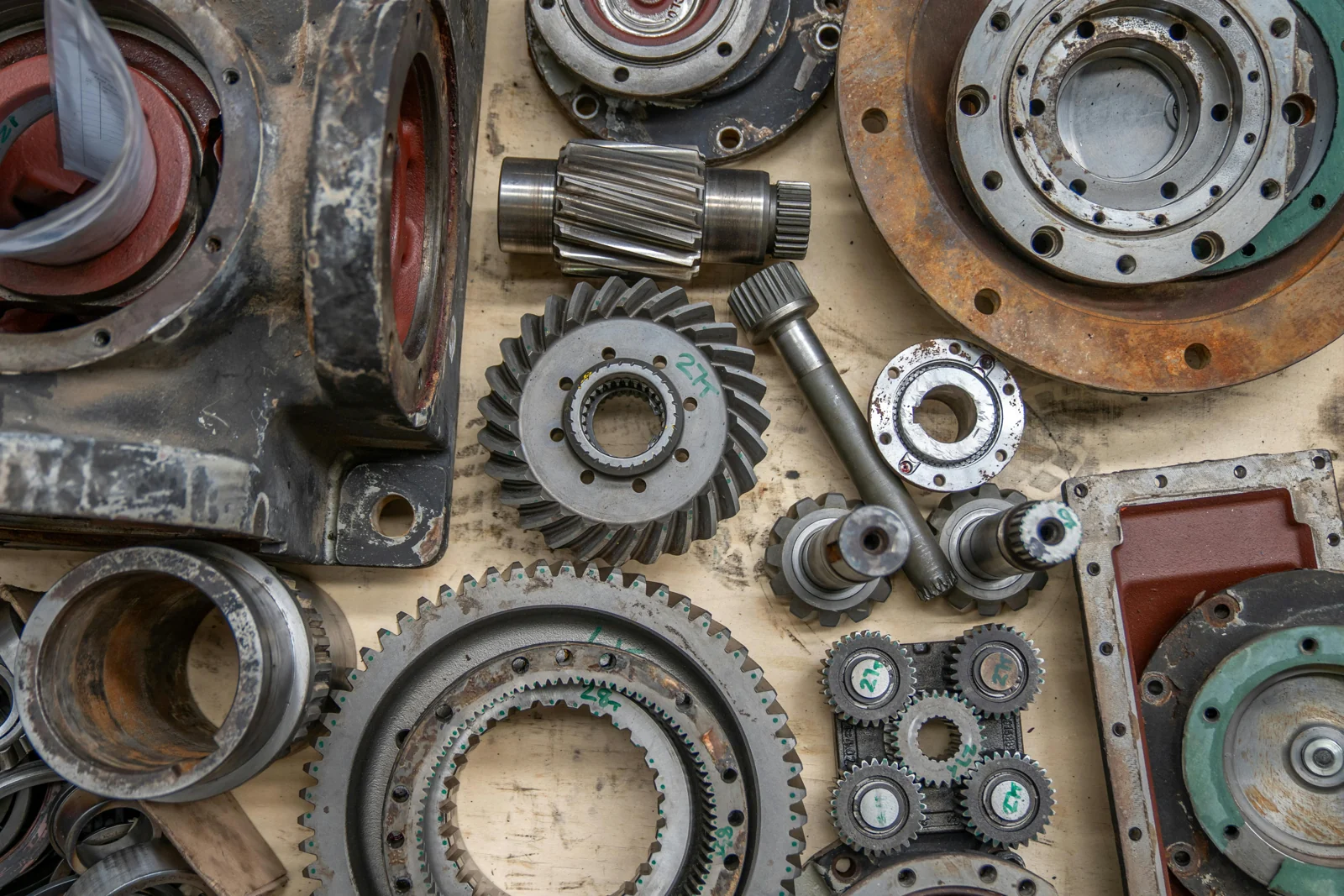 Dismantled industrial gearbox components laid out for inspection